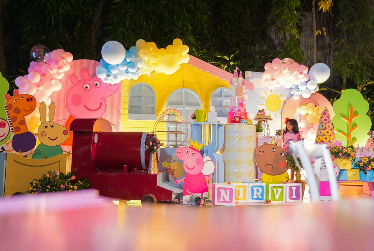 Peppa themed children's party stage with balloons and cake table