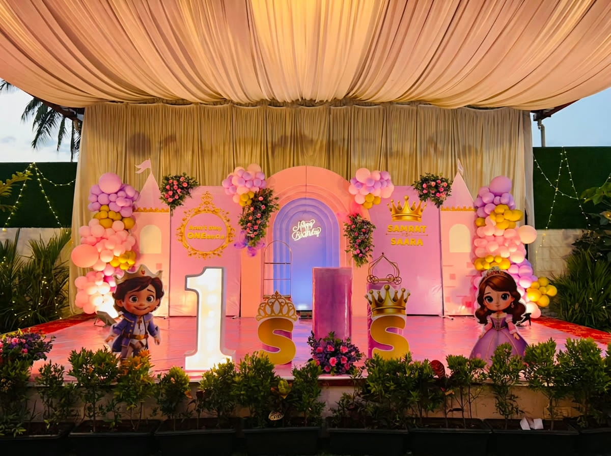Pink princess castle themed birthday stage at dusk
